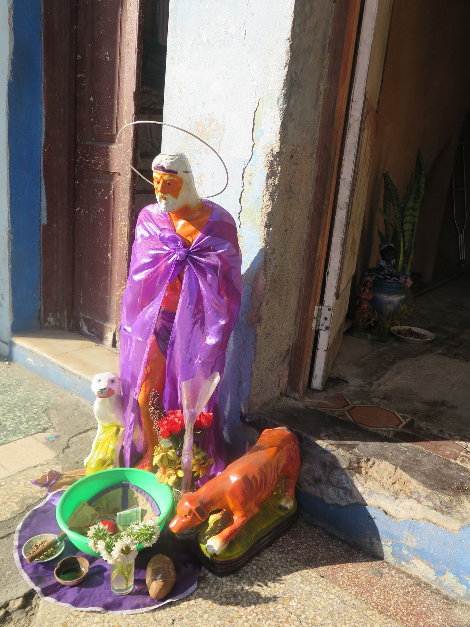 san lazaro, saint lazaro, celebration, worship, religion, santeria, catholicism, catholic, cuba, cuban, cuban streets, cuban celebration, streets of cuba, saint, patron saint of suffering, caribbean island, worshippers, altar, street altar