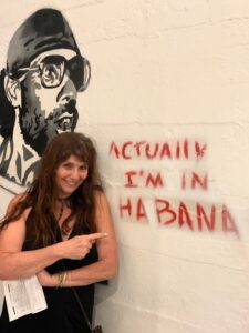 Havana graffiti wall with Tour leader Gabriella Klein leaning against the wall